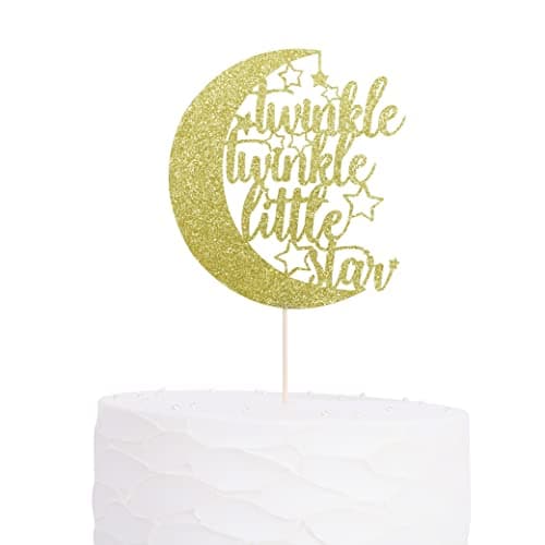 Gold glitter crescent moon cake topper with twinkle twinkle little star script and small stars, on a white frosted cake
