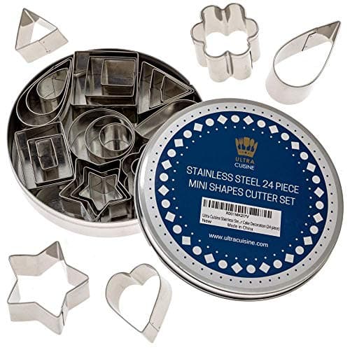Ultra Cuisine 24-piece mini stainless steel cookie cutter set in round storage tin, showing 8 shapes including star, flower, heart, and round in three sizes